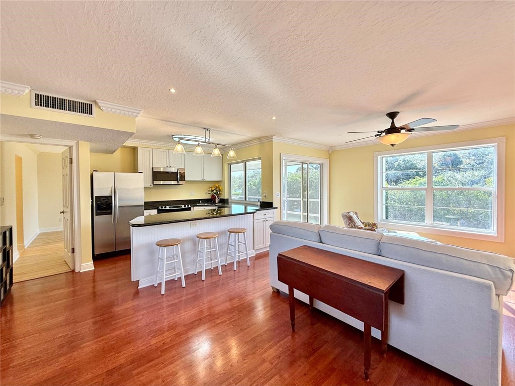 200 Greytwig Road, Unit 212 Vero Beach, FL 32963 - Photo 13 of 30 a living room with stainless steel appliances kitchen island granite countertop furniture and a large window
