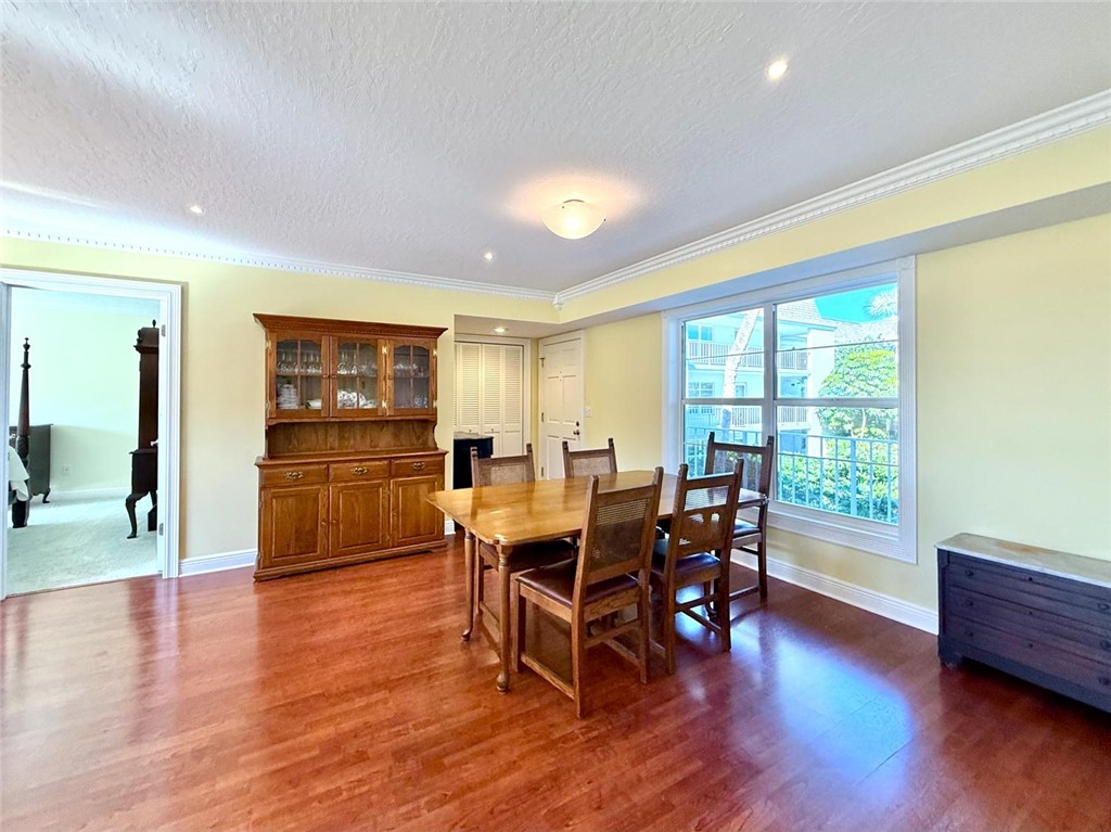 200 Greytwig Road, Unit 212 Vero Beach, FL 32963 - Photo 14 of 30 a view of a dining room with furniture and wooden floor
