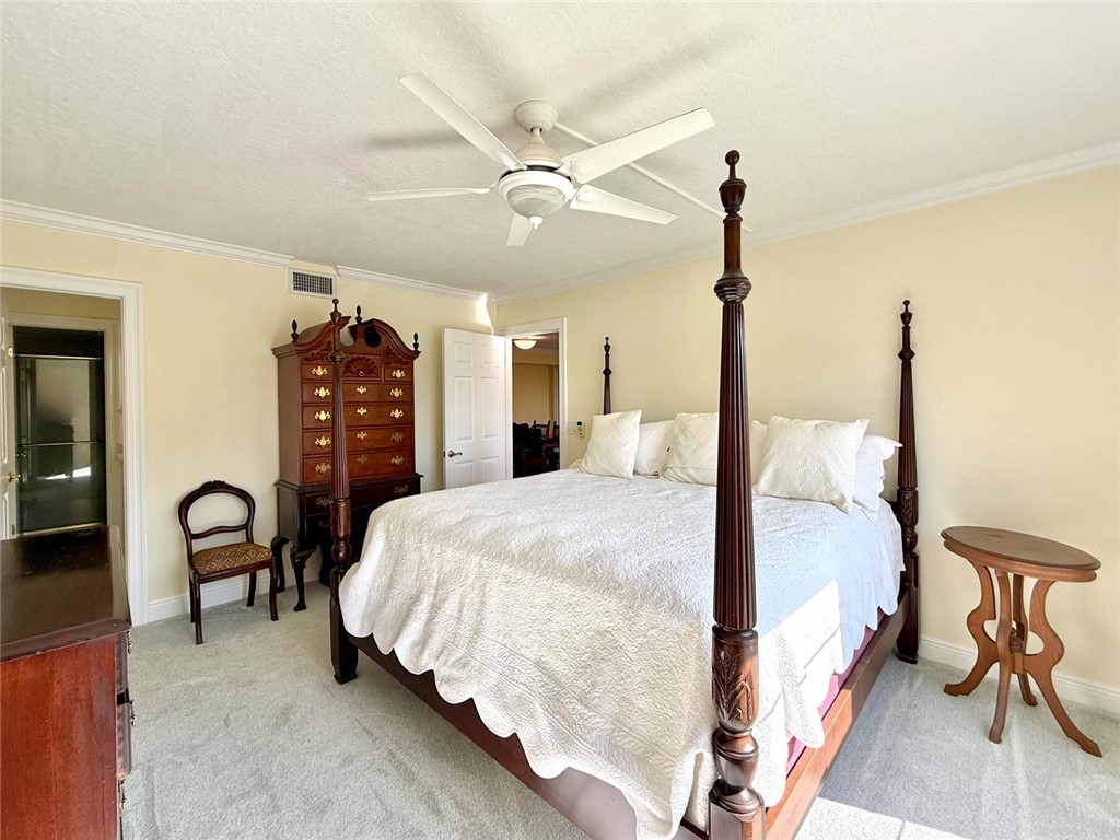 200 Greytwig Road, Unit 212 Vero Beach, FL 32963 - Photo 20 of 30 a bedroom with bed and a chair