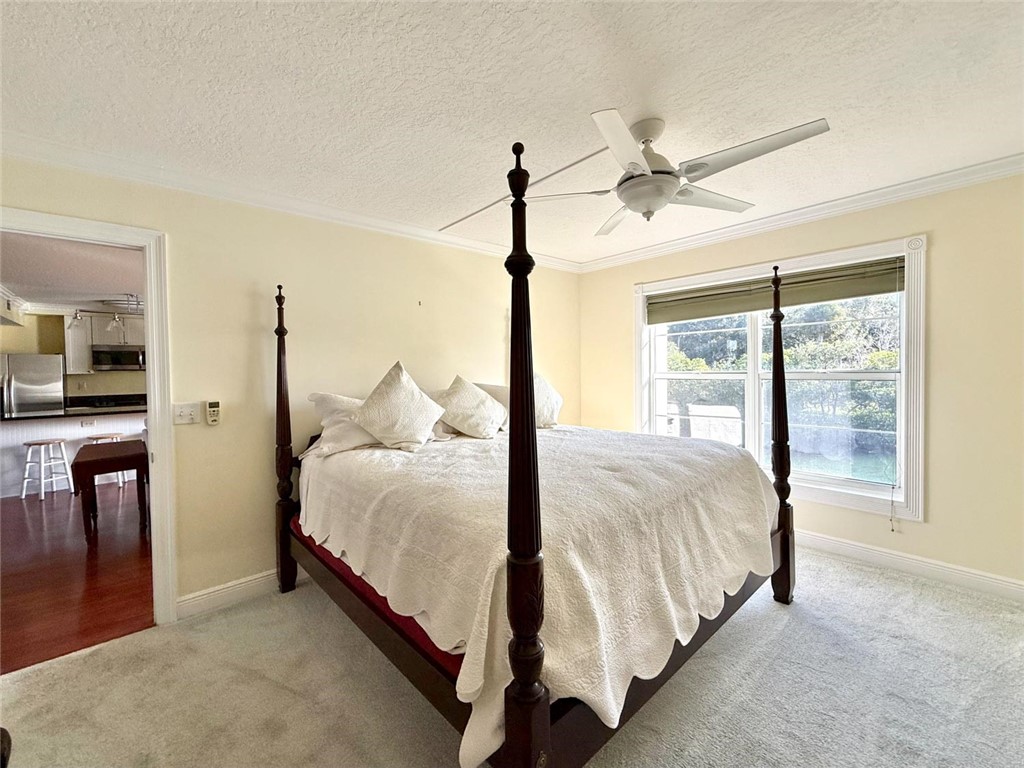 200 Greytwig Road, Unit 212 Vero Beach, FL 32963 - Photo 21 of 30 a bed sitting in a spacious bedroom next to a window