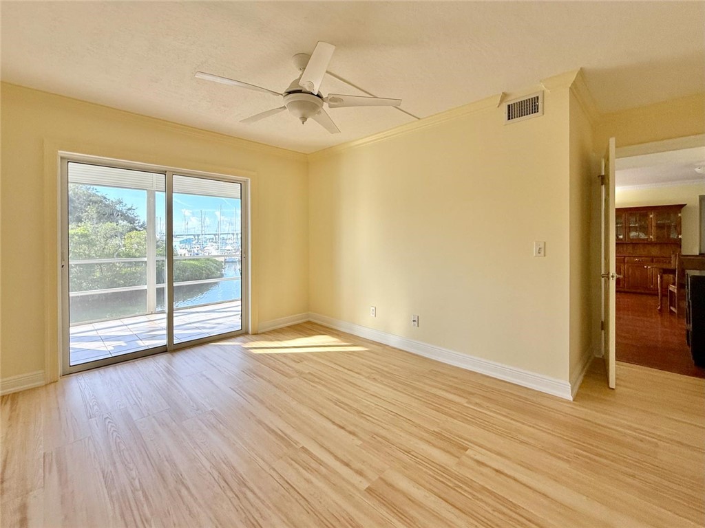 200 Greytwig Road, Unit 212 Vero Beach, FL 32963 - Photo 24 of 30 a view of an empty room with wooden floor and a window