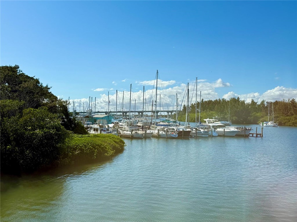 200 Greytwig Road, Unit 212 Vero Beach, FL 32963 - Photo 28 of 30 a view of a ocean with boats and trees in the background