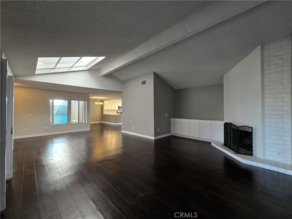 2595 Laramie Road Riverside, CA 92506 - Photo 11 of 29 a view of an empty room with wooden floor and a window