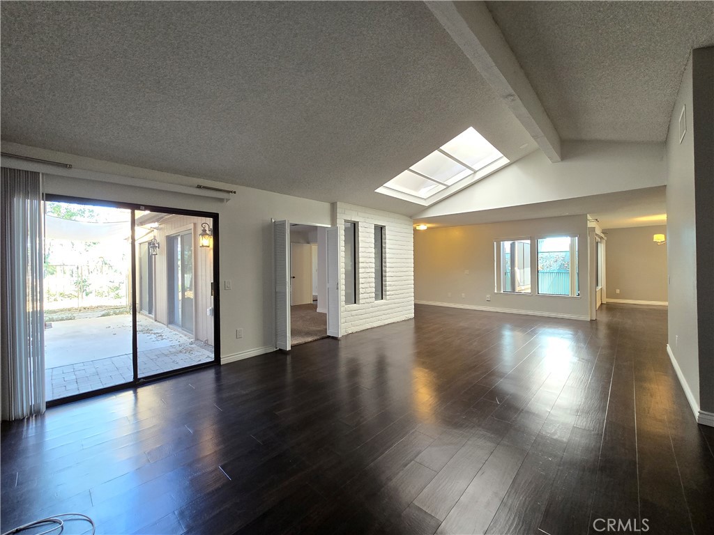 2595 Laramie Road Riverside, CA 92506 - Photo 12 of 29 a view of an empty room with wooden floor and a window