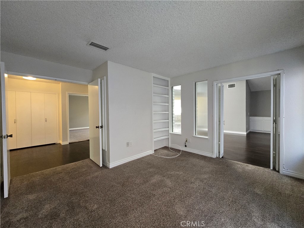 2595 Laramie Road Riverside, CA 92506 - Photo 14 of 29 an empty room with windows and closet