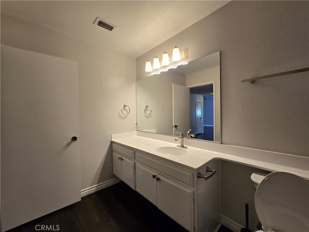 2595 Laramie Road Riverside, CA 92506 - Photo 22 of 29 a bathroom with a double vanity sink and a mirror