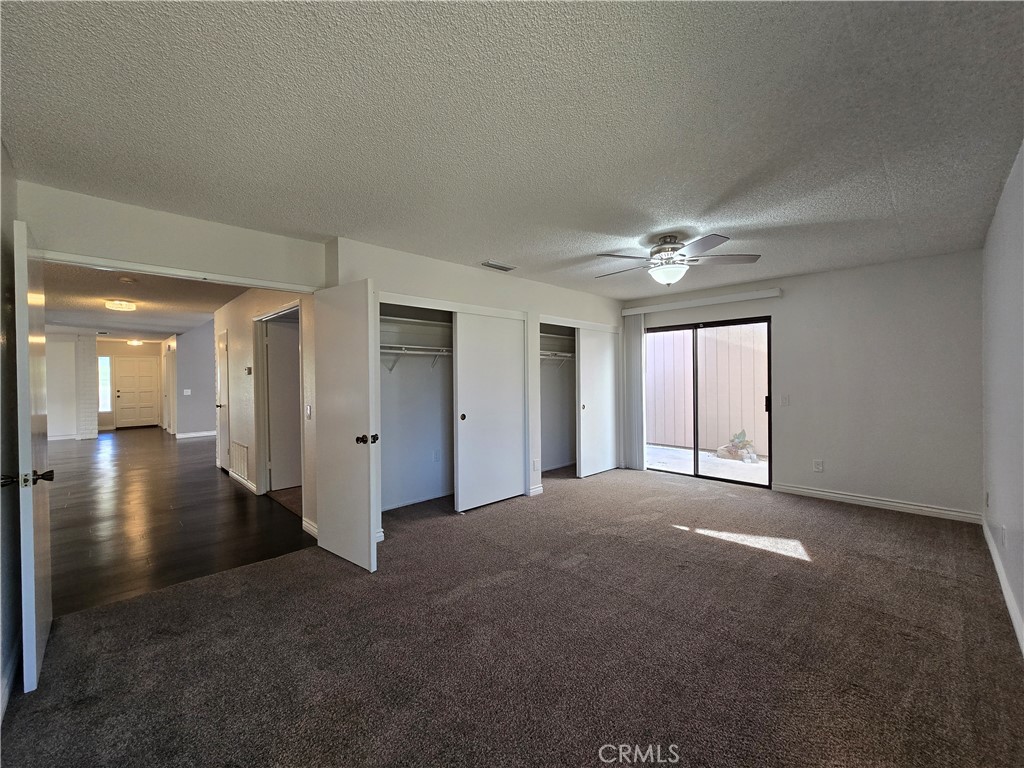2595 Laramie Road Riverside, CA 92506 - Photo 24 of 29 a view of a big room with windows and chandelier fan