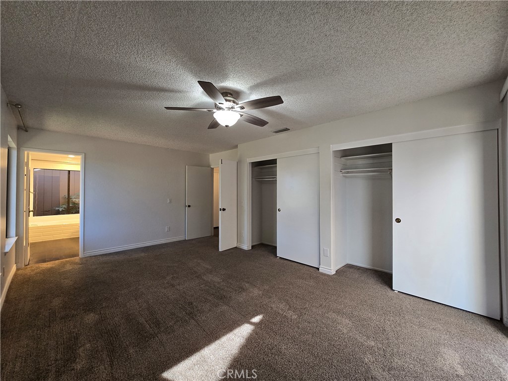 2595 Laramie Road Riverside, CA 92506 - Photo 25 of 29 a view of a room with a ceiling fan and a window