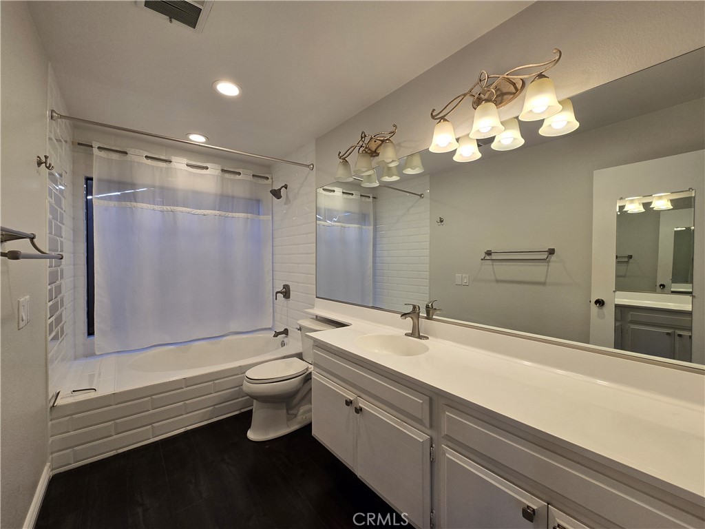 2595 Laramie Road Riverside, CA 92506 - Photo 26 of 29 a bathroom with a double vanity sink mirror and toilet