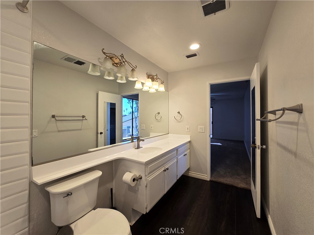 2595 Laramie Road Riverside, CA 92506 - Photo 27 of 29 a bathroom with a sink a toilet and shower