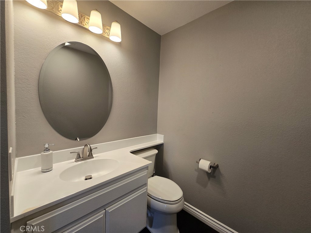 2595 Laramie Road Riverside, CA 92506 - Photo 6 of 29 a bathroom with a sink mirror vanity and toilet