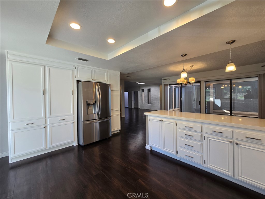 2595 Laramie Road Riverside, CA 92506 - Photo 9 of 29 a large room with a lot of wooden floor and staircase