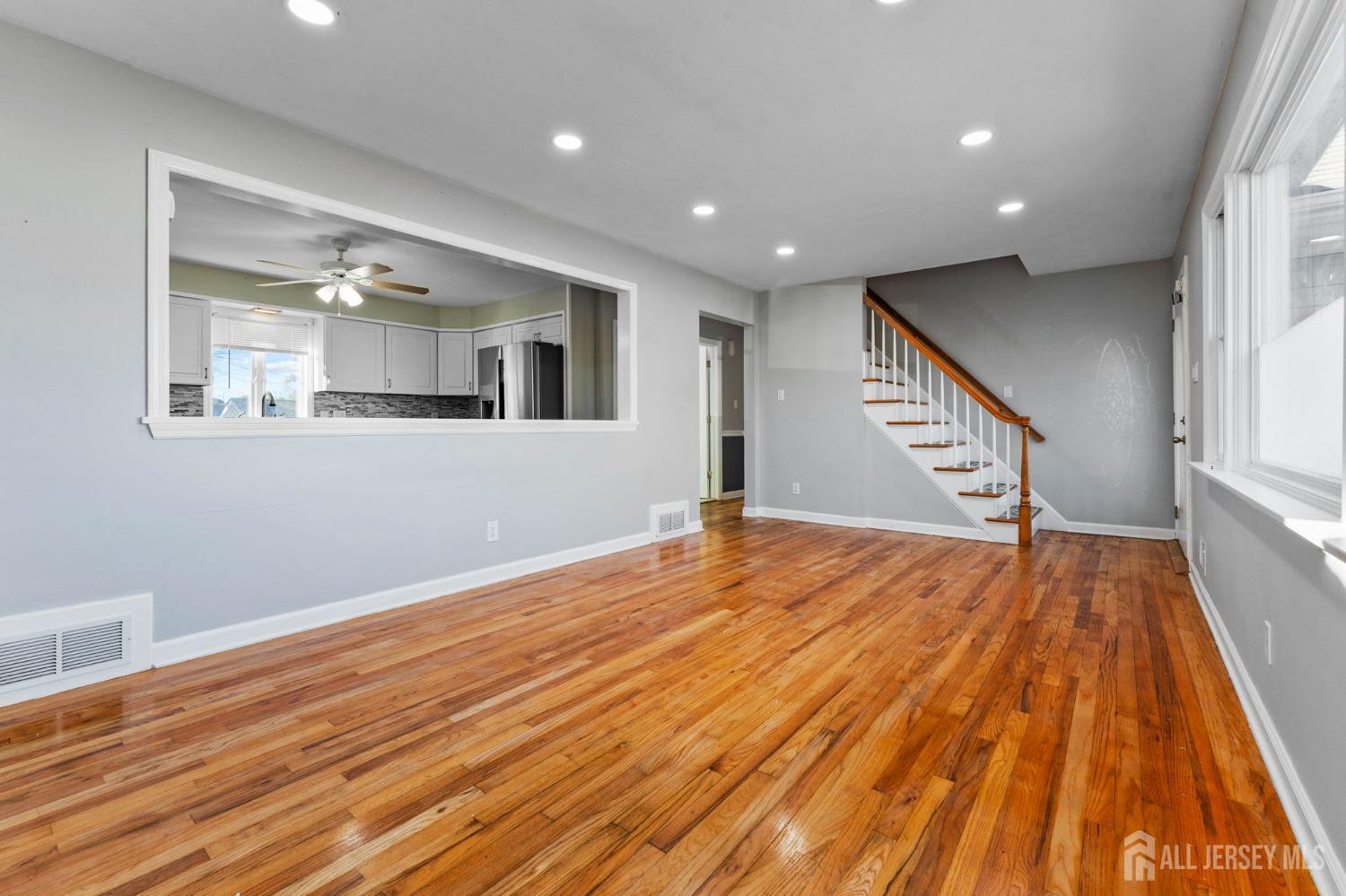 23 Alton Road Hamilton, NJ 08619 - Photo 17 of 40 a view of an empty room with wooden floor and stairs