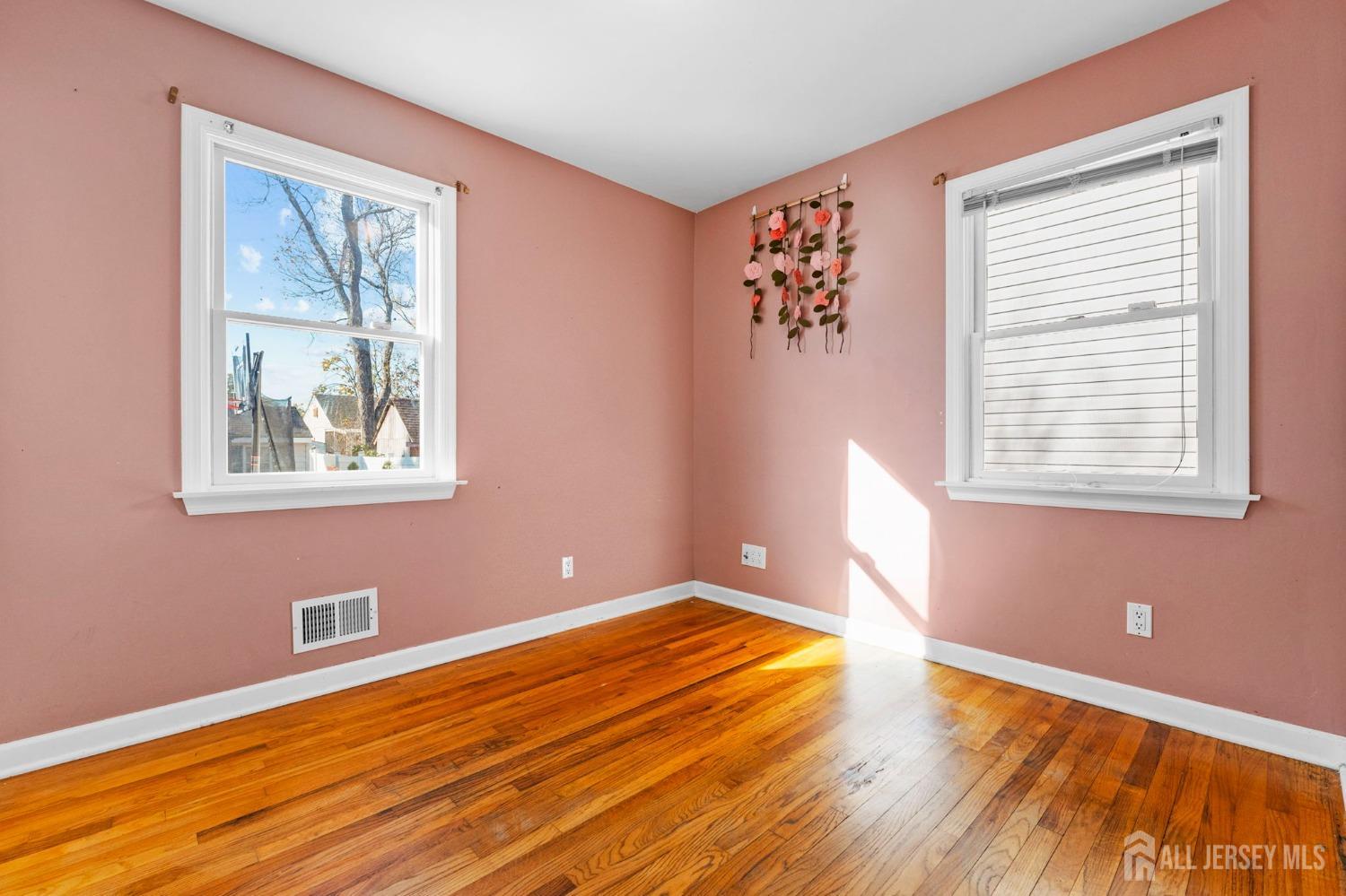 23 Alton Road Hamilton, NJ 08619 - Photo 27 of 40 a view of empty room with wooden floor and fan