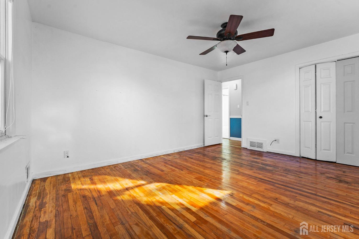 23 Alton Road Hamilton, NJ 08619 - Photo 28 of 40 a view of empty room with wooden floor and fan