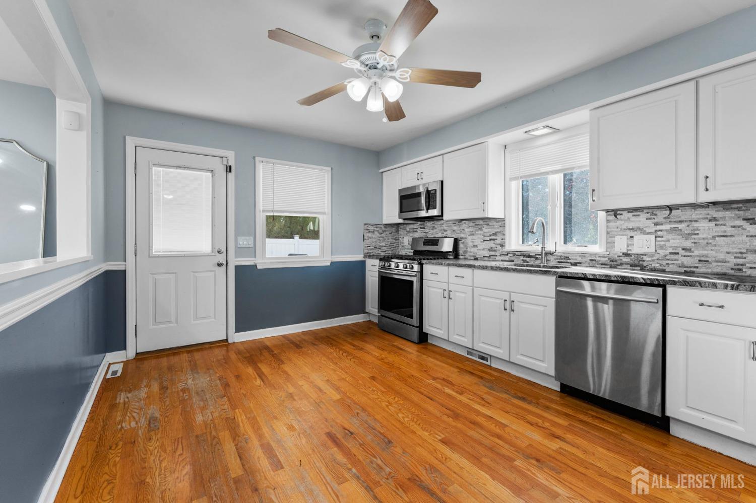 23 Alton Road Hamilton, NJ 08619 - Photo 33 of 40 a kitchen with stainless steel appliances granite countertop a sink cabinets and wooden floor