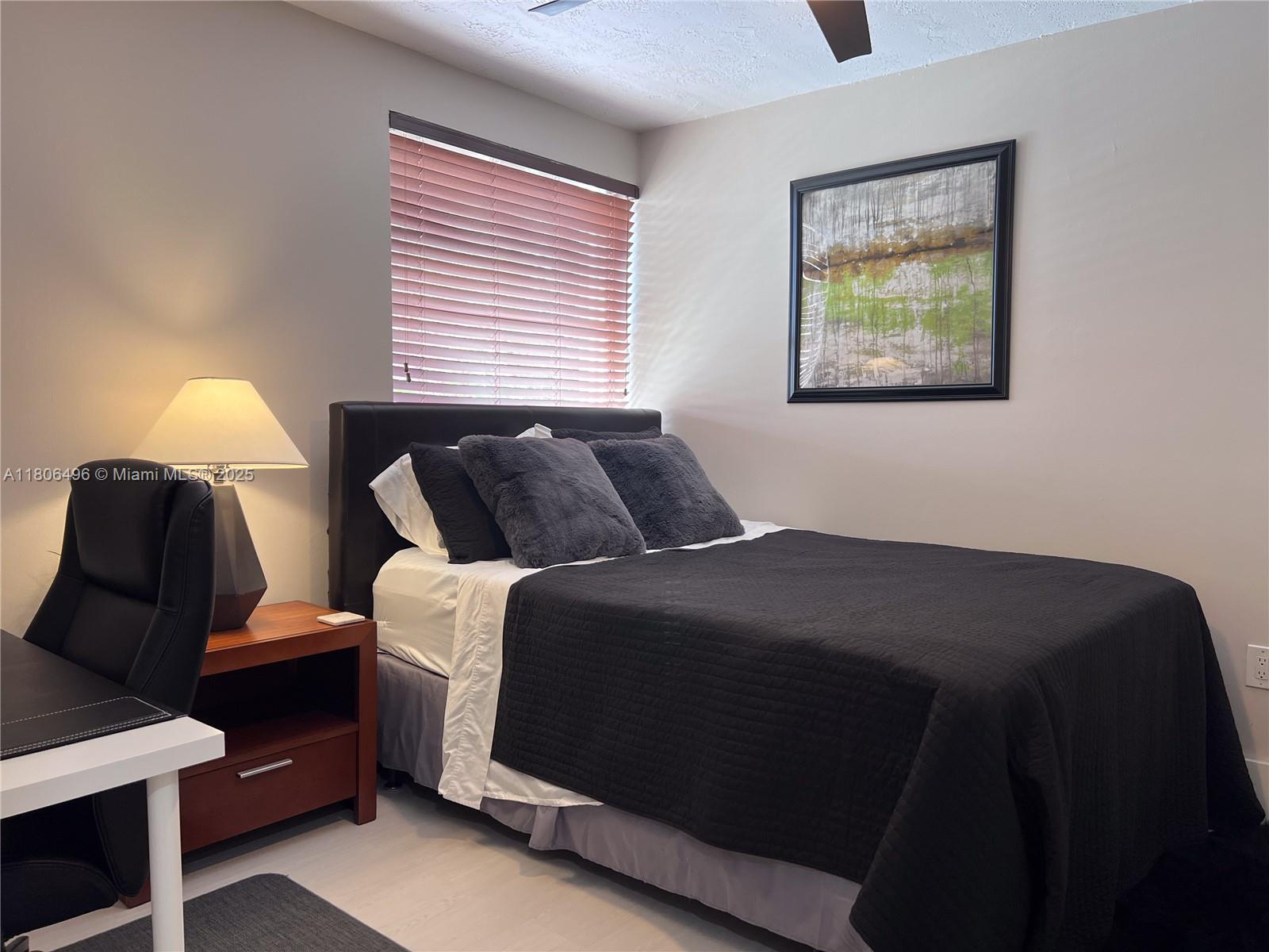 4530 Southwest 68th Ct Circle, Unit 316 Miami, FL 33155 - Photo 14 of 26 a bedroom with a bed and window