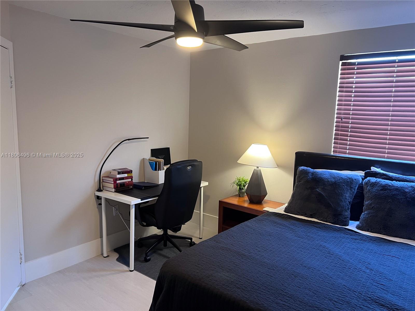 4530 Southwest 68th Ct Circle, Unit 316 Miami, FL 33155 - Photo 15 of 26 a bedroom with a bed a desk and chair