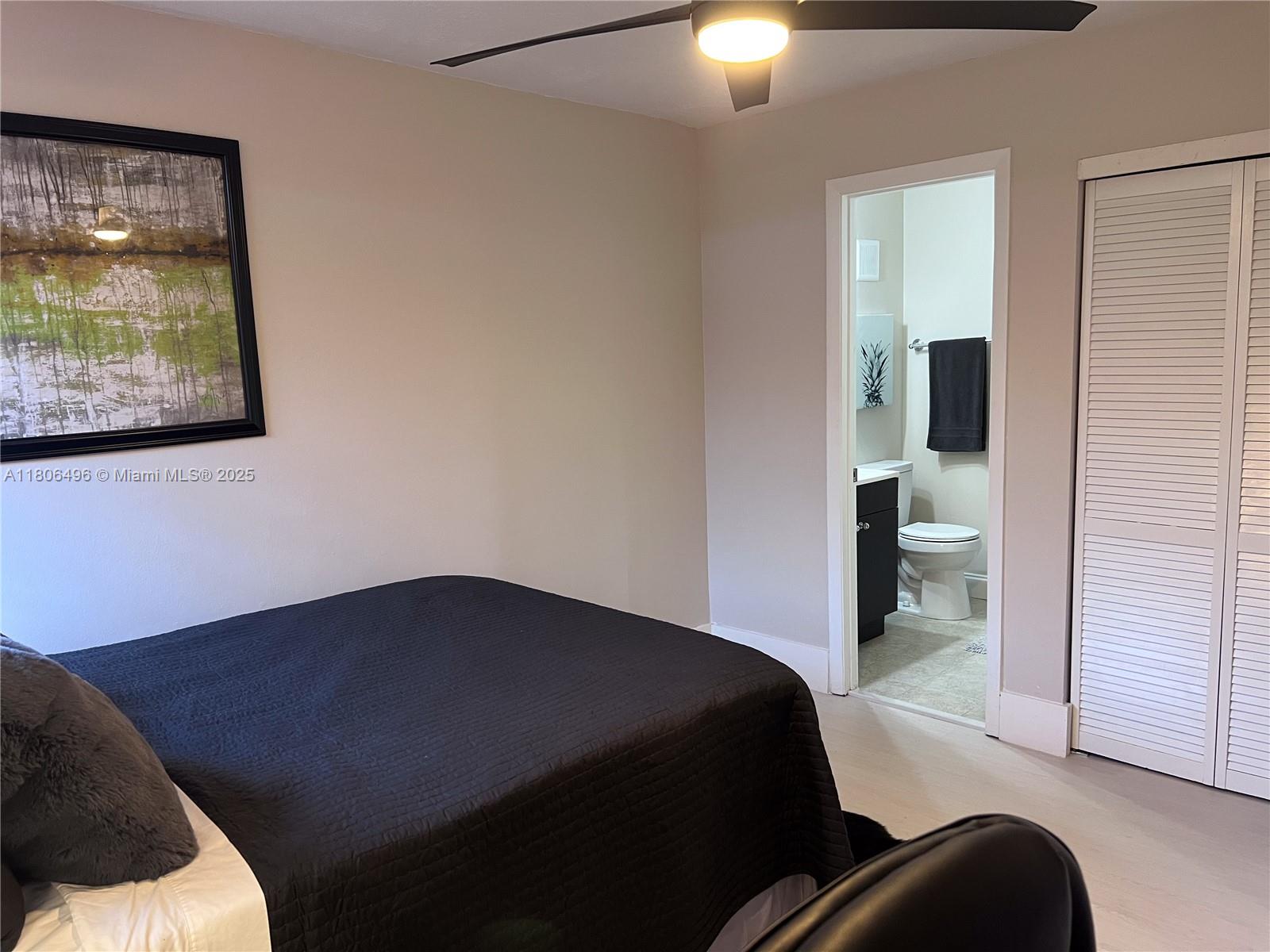 4530 Southwest 68th Ct Circle, Unit 316 Miami, FL 33155 - Photo 16 of 26 a bedroom with a bed and a painting on the wall