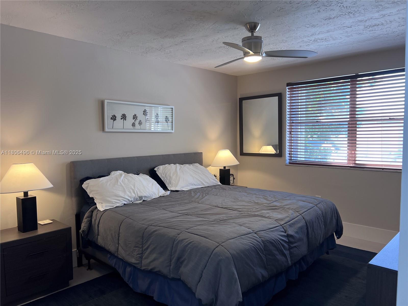 4530 Southwest 68th Ct Circle, Unit 316 Miami, FL 33155 - Photo 19 of 26 a bedroom with a bed and a lamp
