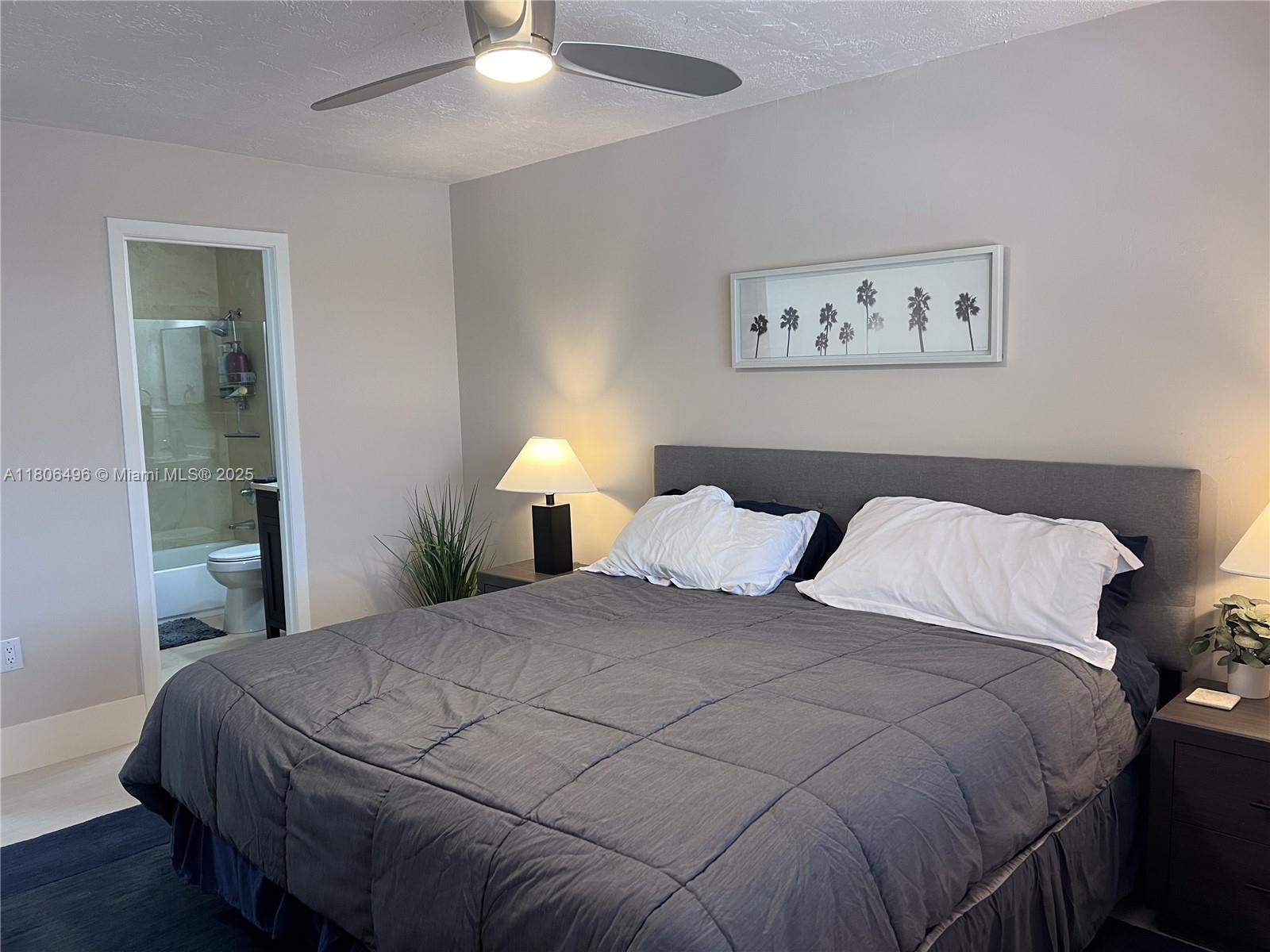 4530 Southwest 68th Ct Circle, Unit 316 Miami, FL 33155 - Photo 20 of 26 a bedroom with a bed and a lamp