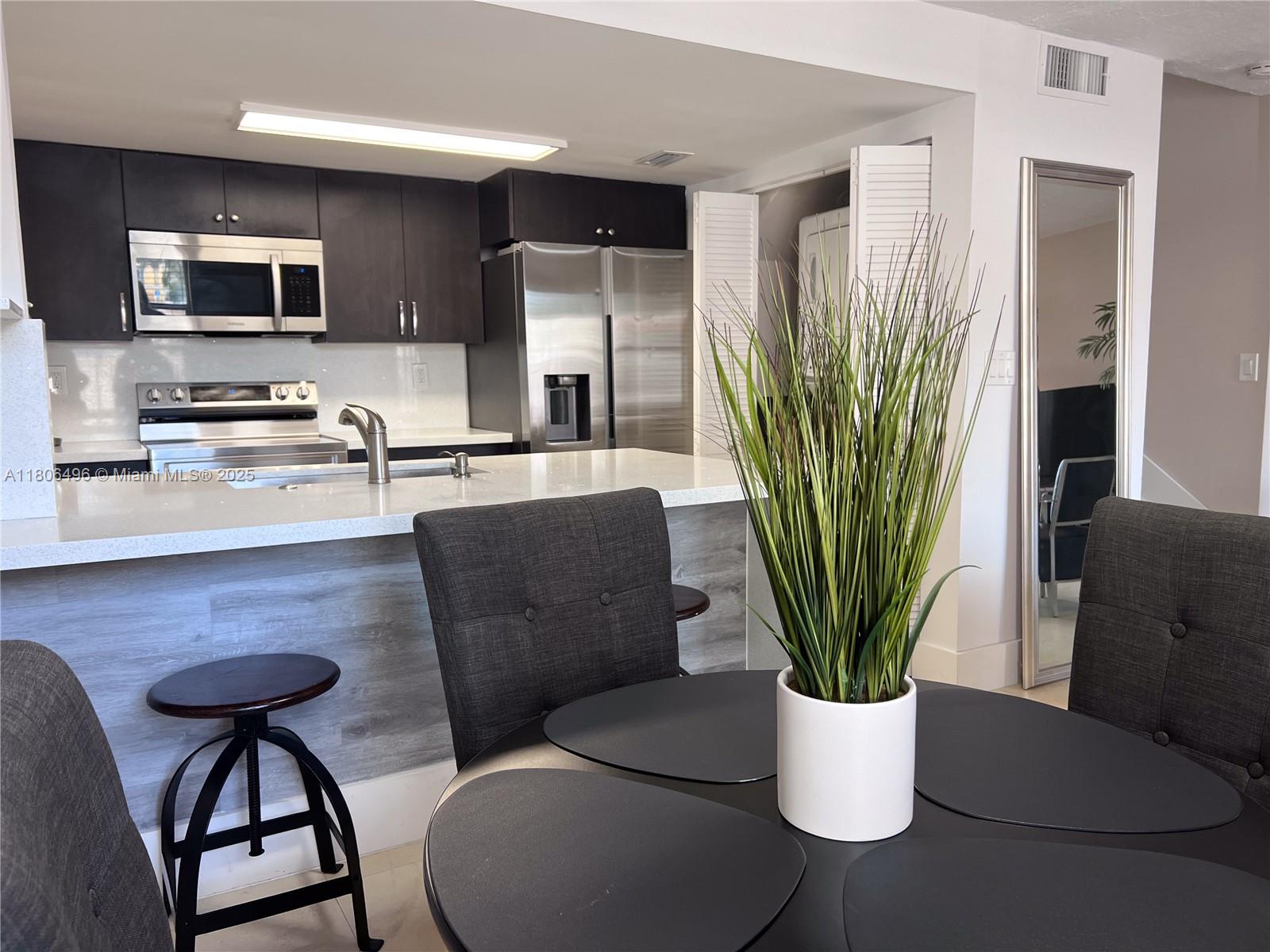 4530 Southwest 68th Ct Circle, Unit 316 Miami, FL 33155 - Photo 2 of 26 a living room with furniture a large window and a potted plant