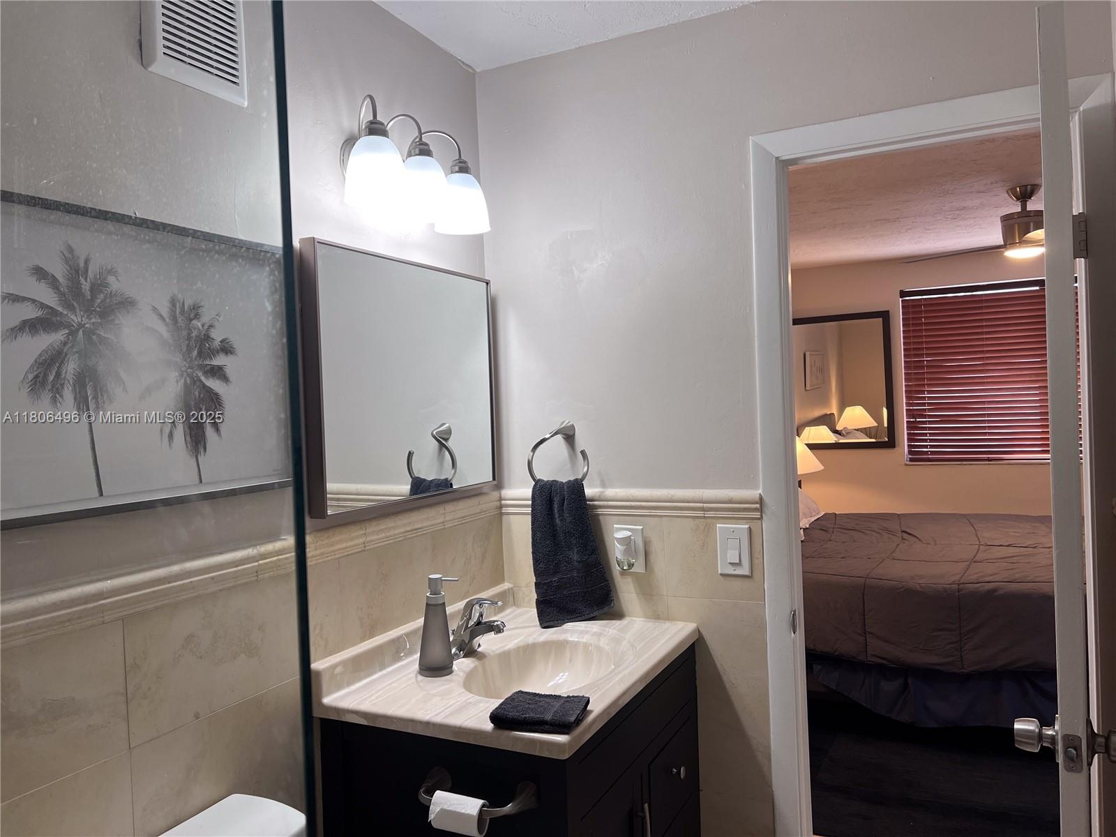 4530 Southwest 68th Ct Circle, Unit 316 Miami, FL 33155 - Photo 22 of 26 a bathroom with a sink and a mirror