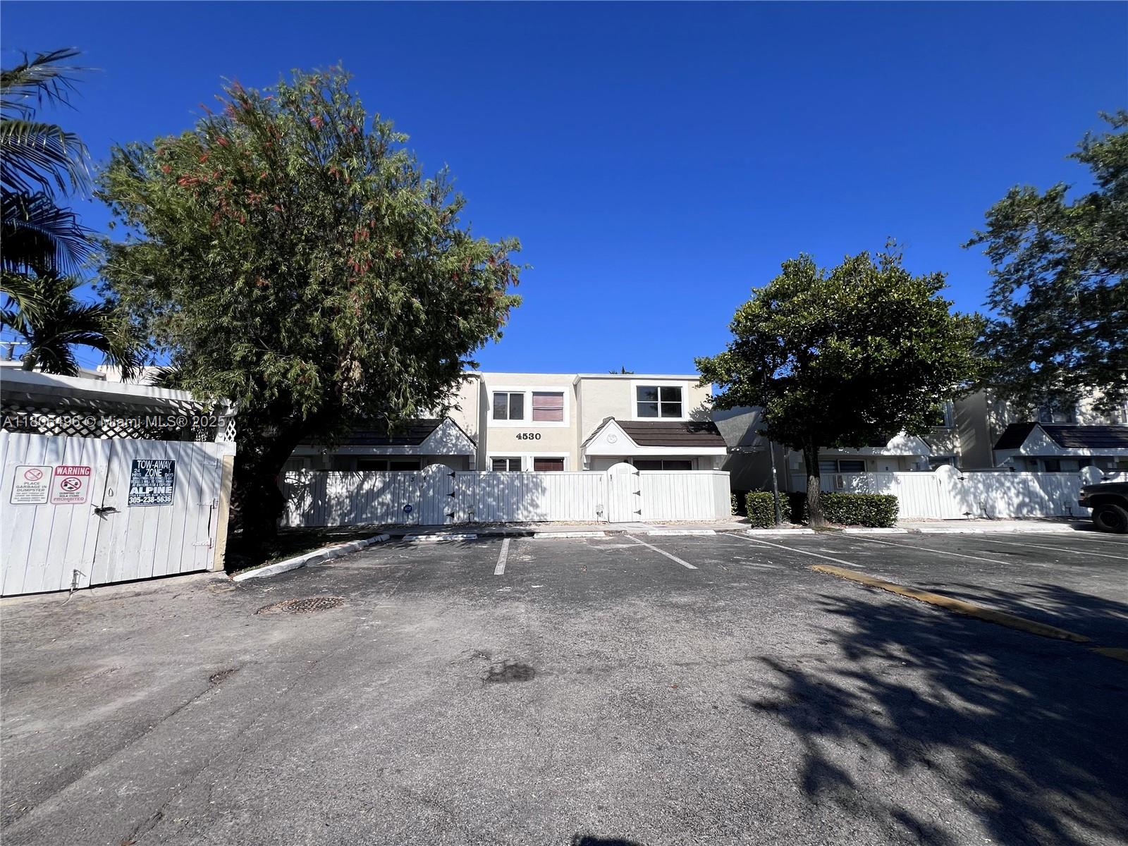 4530 Southwest 68th Ct Circle, Unit 316 Miami, FL 33155 - Photo 26 of 26 a view of a house with a yard and garage