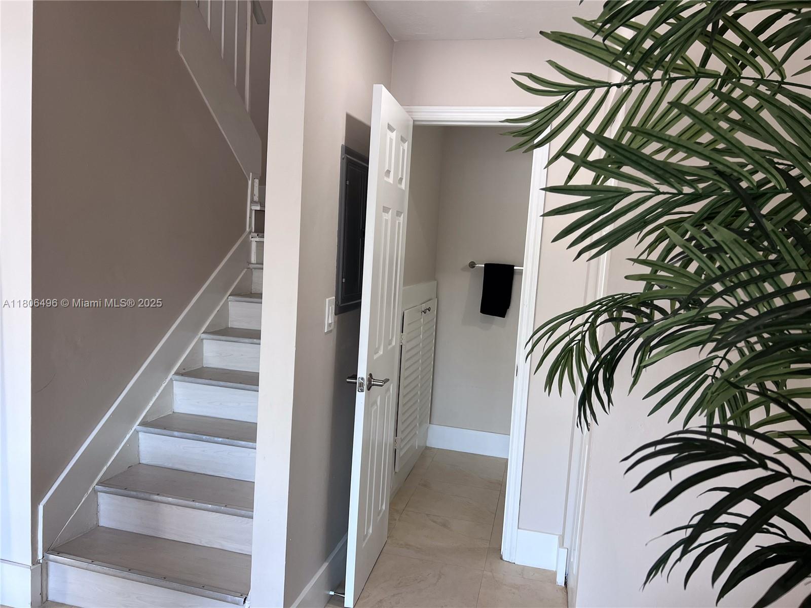 4530 Southwest 68th Ct Circle, Unit 316 Miami, FL 33155 - Photo 3 of 26 a view of a hallway with white walls and stairs