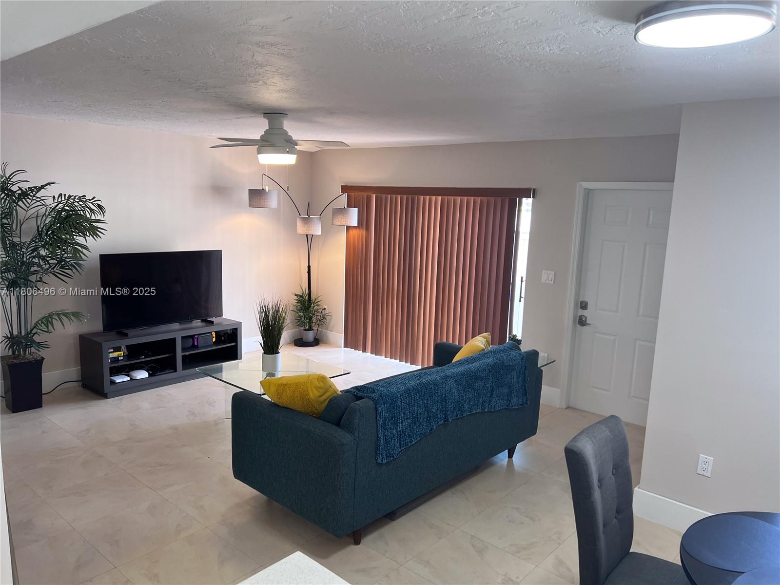 4530 Southwest 68th Ct Circle, Unit 316 Miami, FL 33155 - Photo 5 of 26 a living room with furniture and a flat screen tv