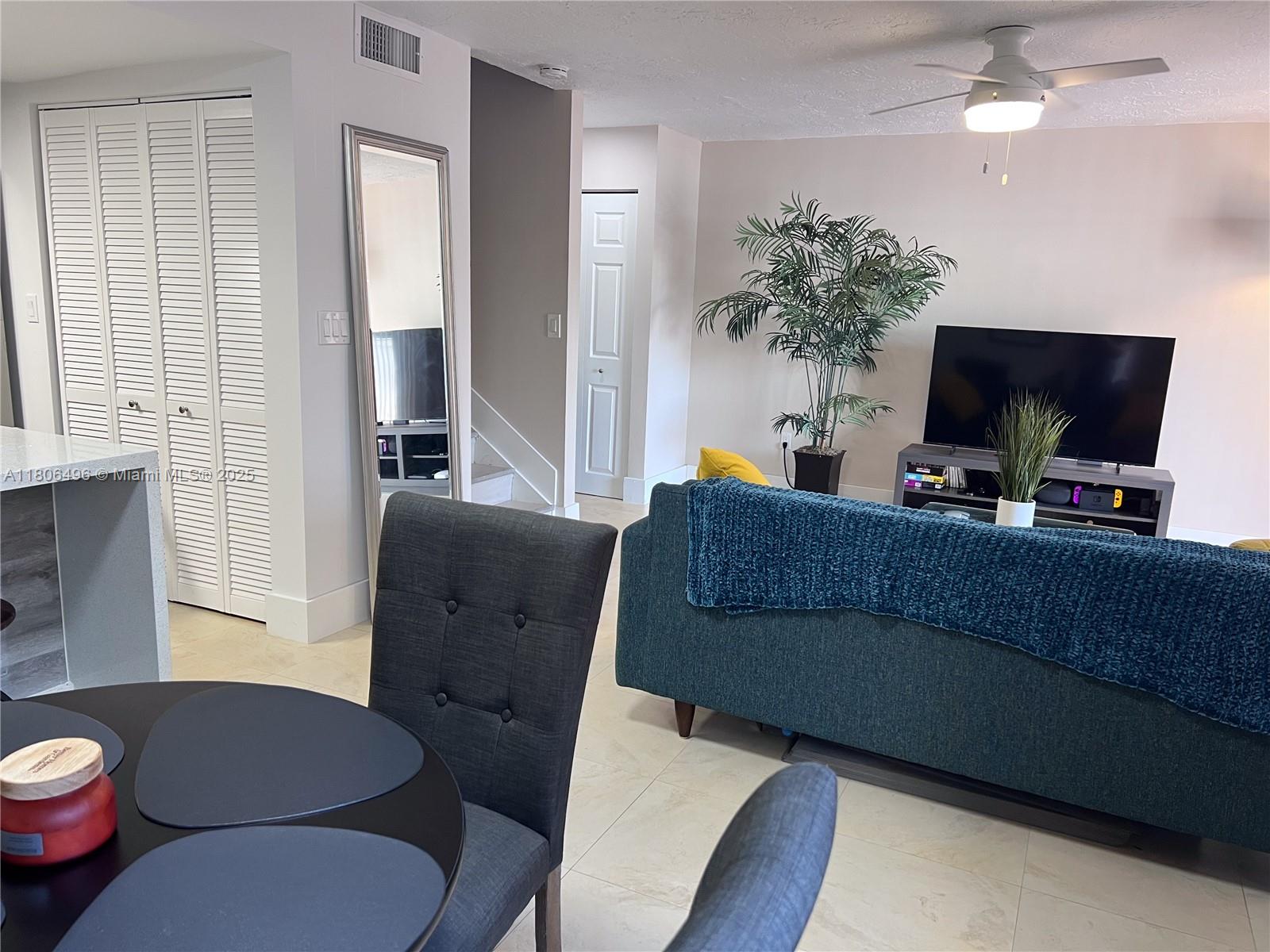 4530 Southwest 68th Ct Circle, Unit 316 Miami, FL 33155 - Photo 6 of 26 a living room with furniture and a flat screen tv