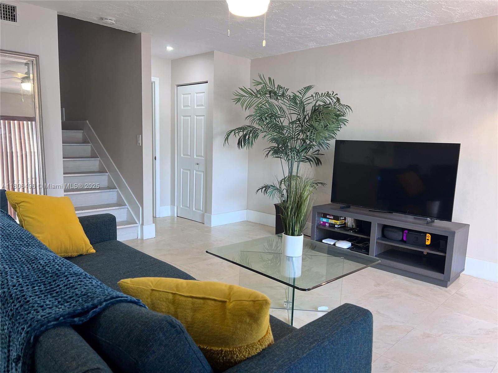 4530 Southwest 68th Ct Circle, Unit 316 Miami, FL 33155 - Photo 8 of 26 a living room with furniture and a flat screen tv