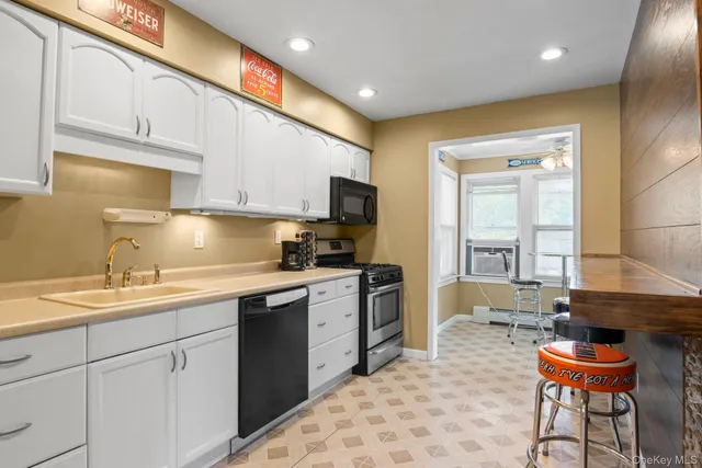 a kitchen with a sink cabinets and window