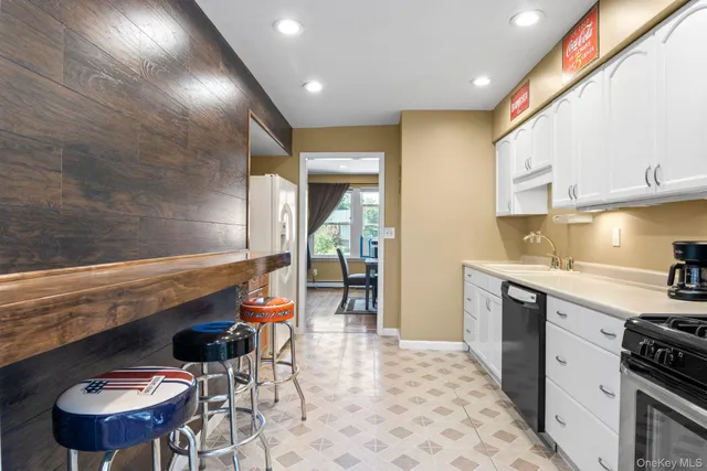 a kitchen with stainless steel appliances kitchen island granite countertop a sink and cabinets