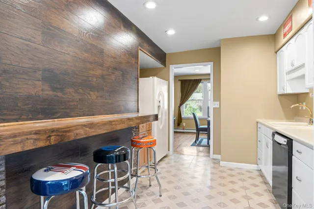a hallway with a sink and breakfast area