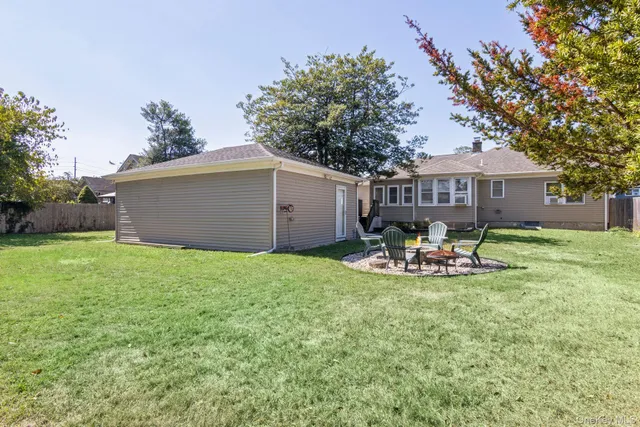 a view of a house with backyard and sitting area