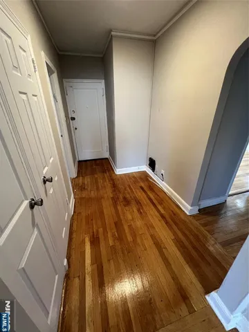 a view of bedroom with a bed and wooden floor