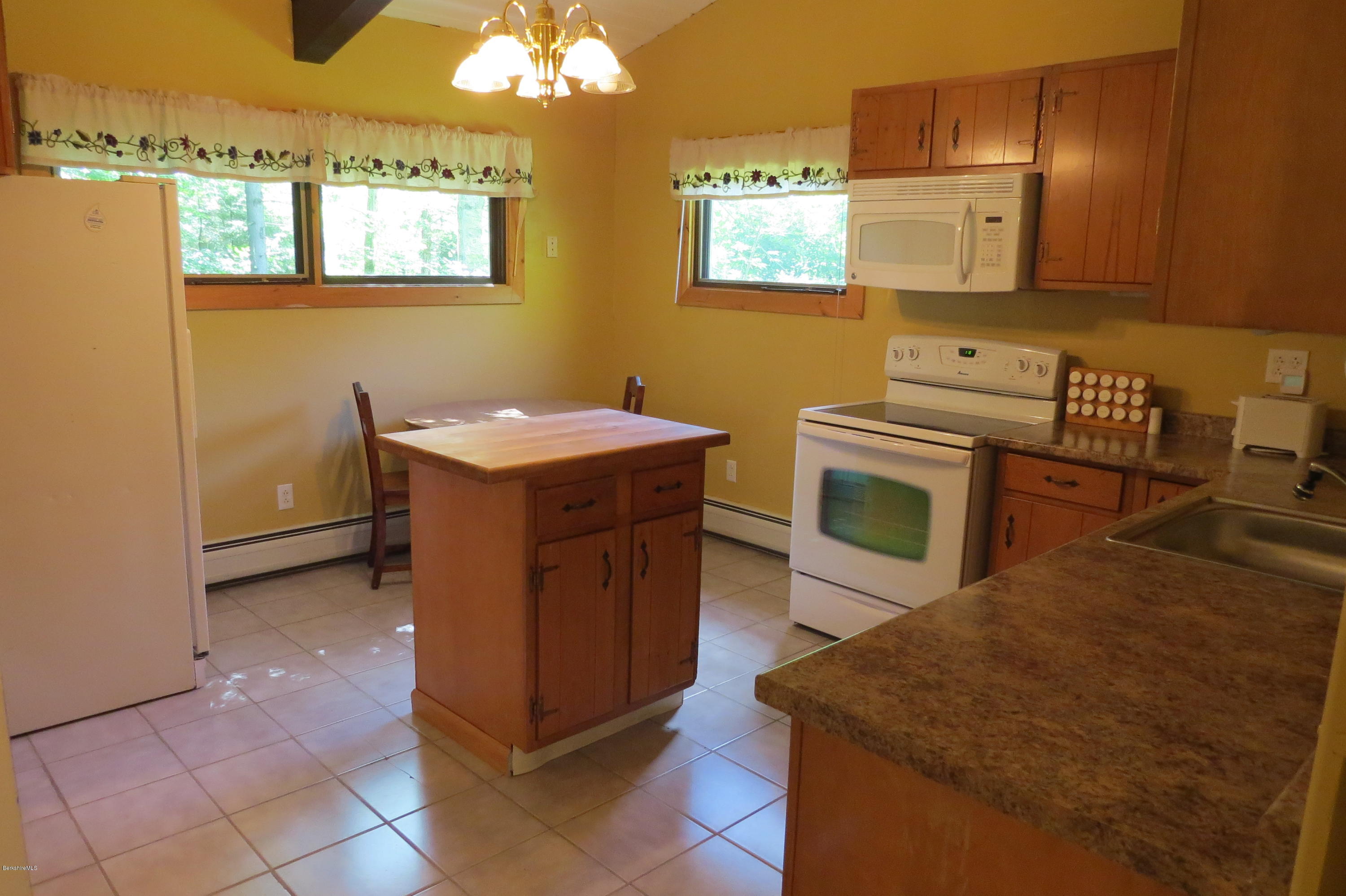 279 Heartwellville View Road Readsboro, VT 05350 - Photo 11 of 42 a kitchen with cabinets and wooden floor