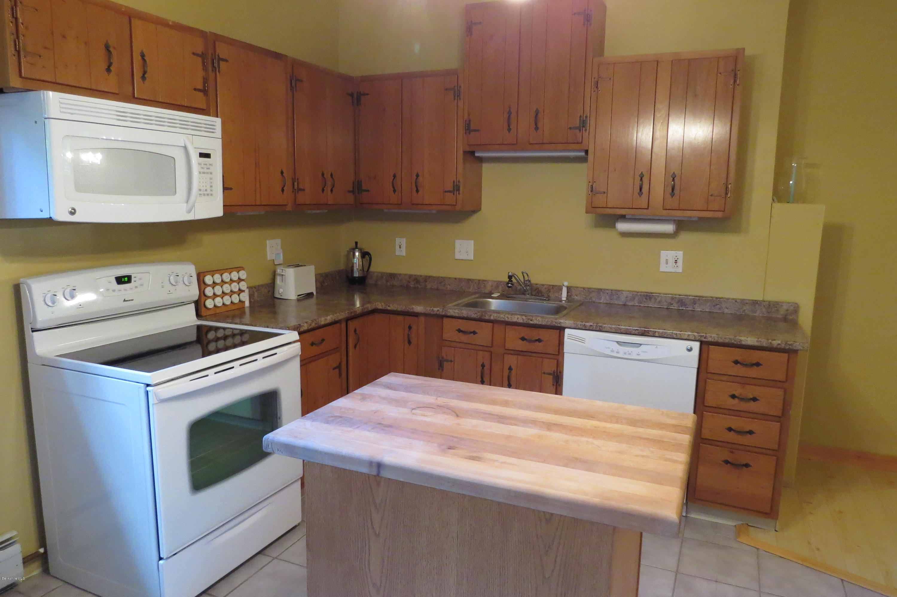 279 Heartwellville View Road Readsboro, VT 05350 - Photo 13 of 42 a kitchen with a stove sink and cabinets