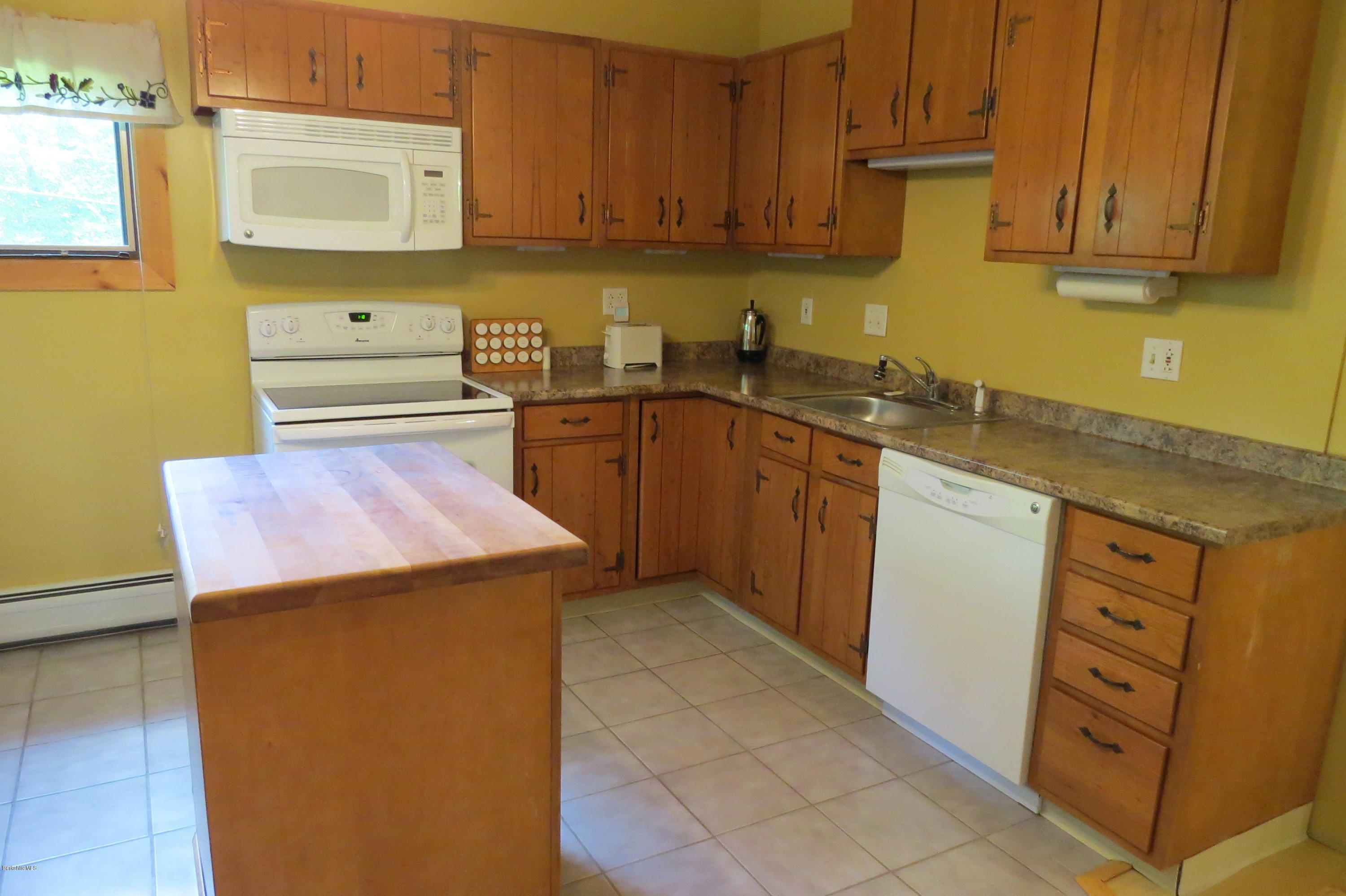 279 Heartwellville View Road Readsboro, VT 05350 - Photo 14 of 42 a kitchen with stainless steel appliances granite countertop a sink stove and cabinets