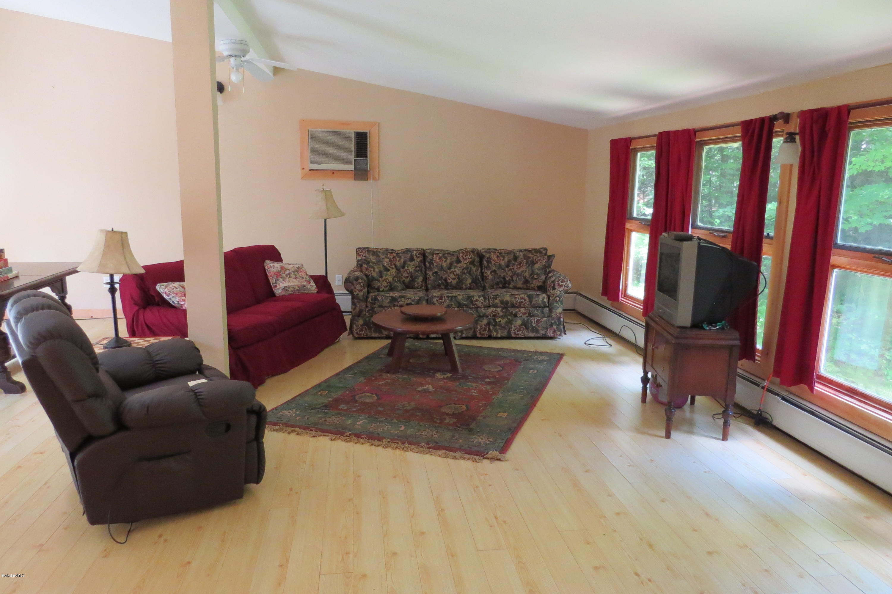 279 Heartwellville View Road Readsboro, VT 05350 - Photo 21 of 42 a living room with furniture fireplace and a flat screen tv