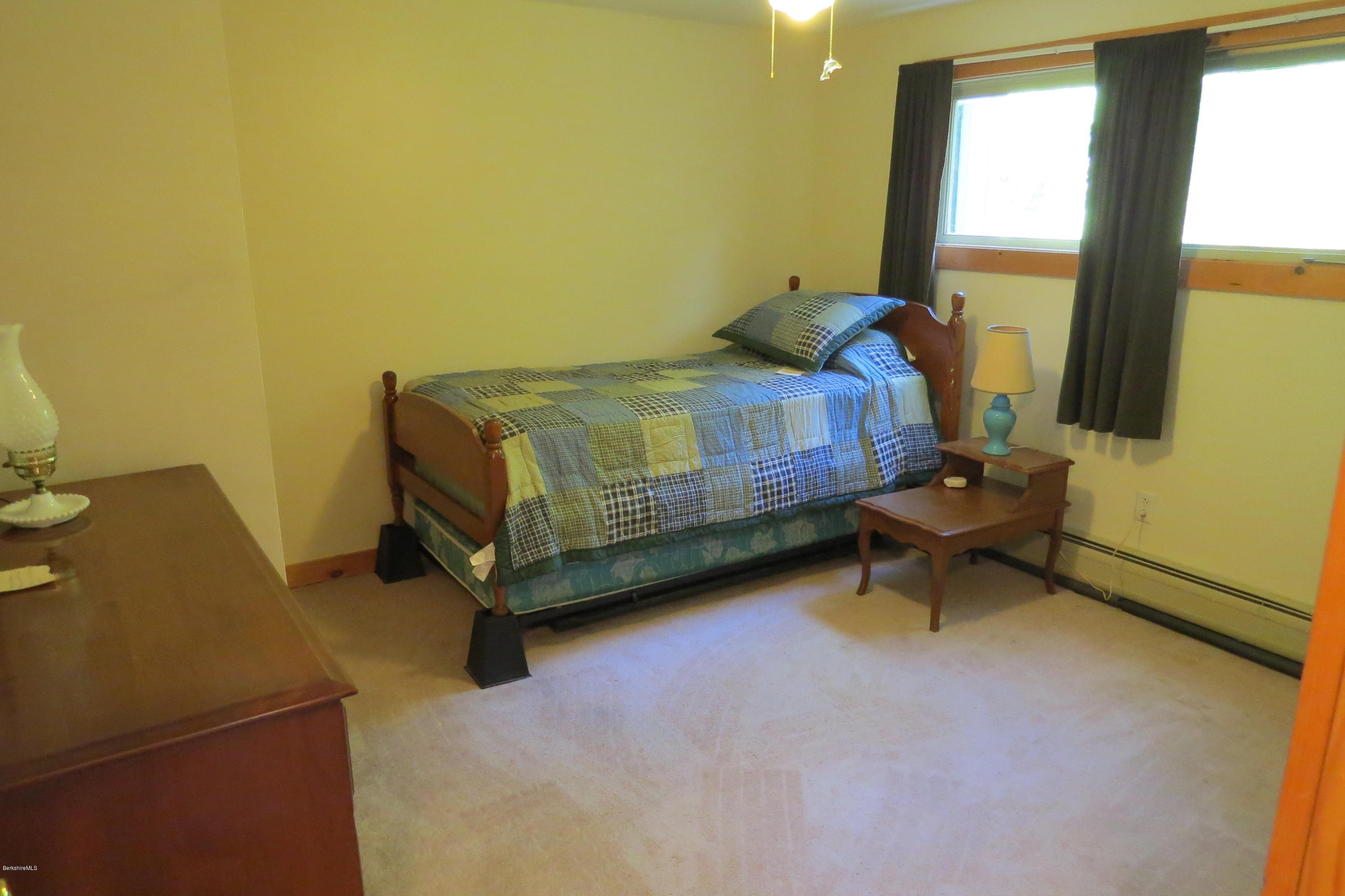 279 Heartwellville View Road Readsboro, VT 05350 - Photo 29 of 42 a bedroom with a bed and a table in it
