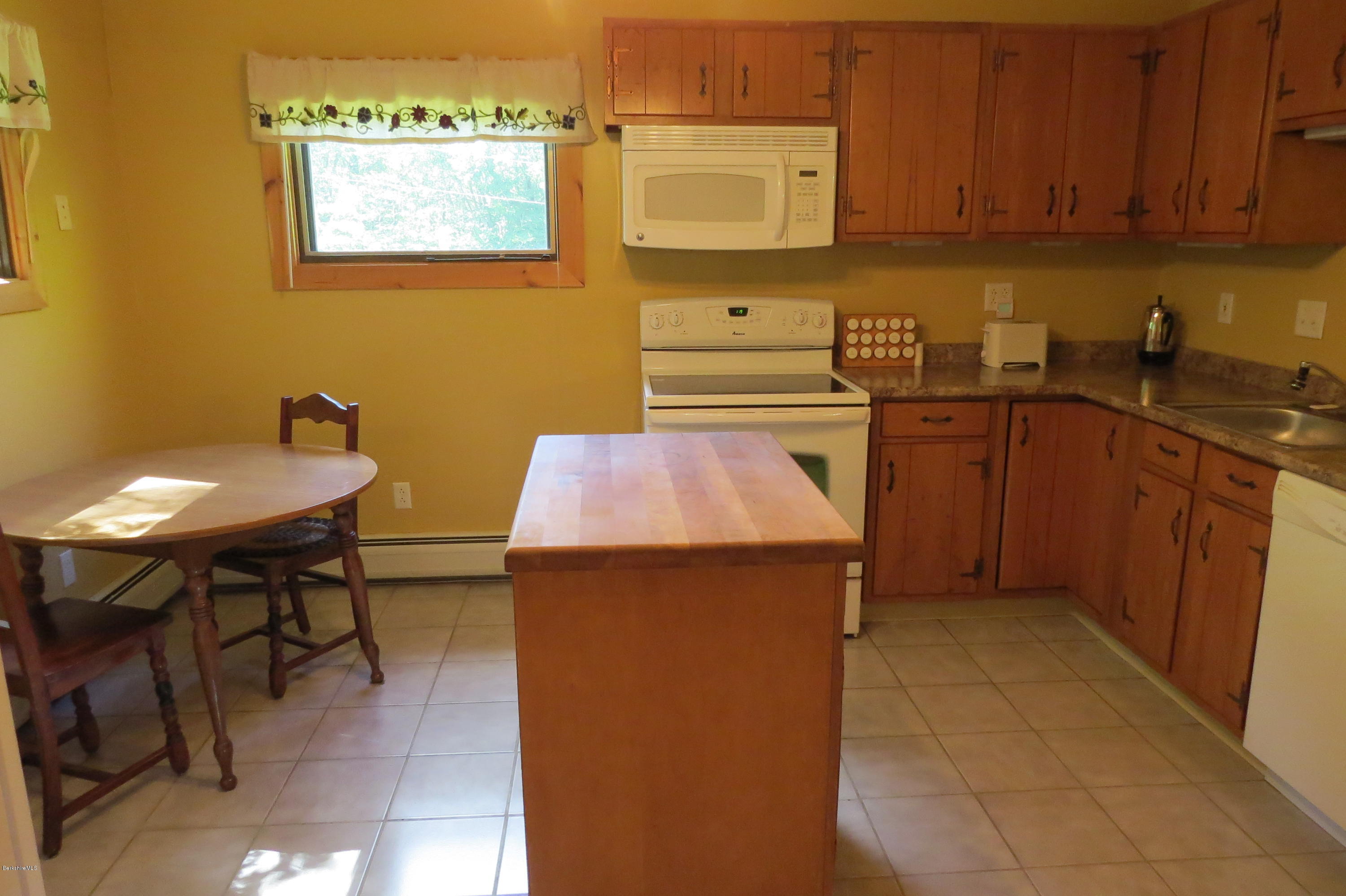279 Heartwellville View Road Readsboro, VT 05350 - Photo 10 of 42 a kitchen with a sink cabinets and wooden floor