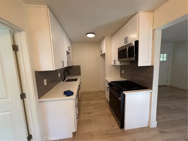 a kitchen with stainless steel appliances a stove microwave and a refrigerator