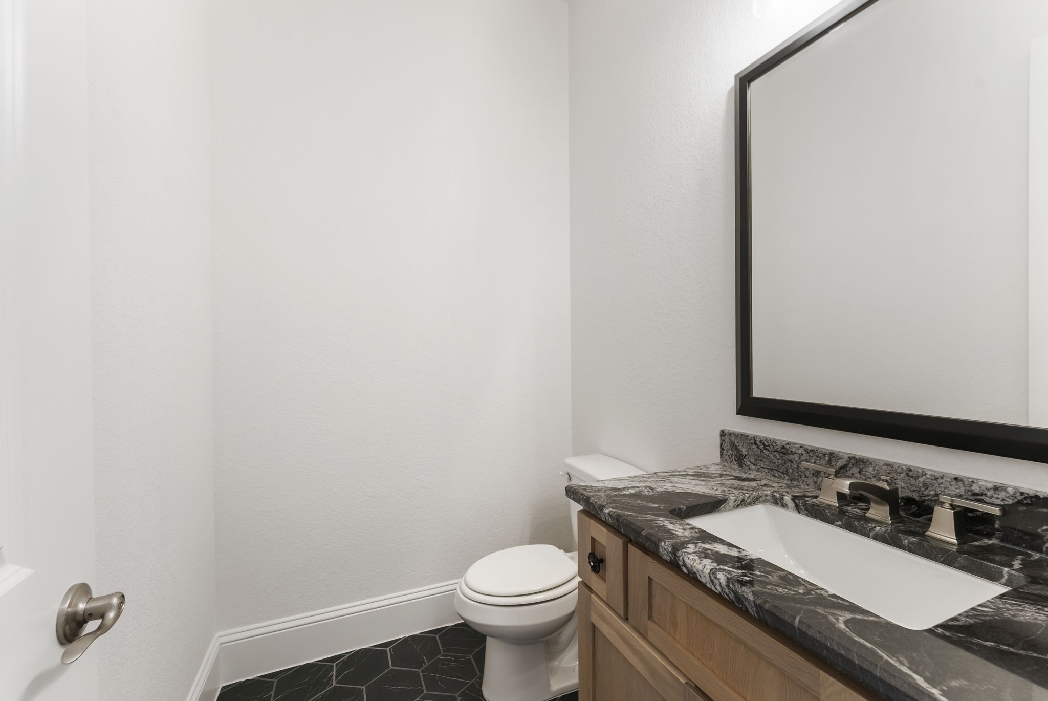 12932 Whitewater Way Conroe, TX 77302 - Photo 20 of 48 For the convenience of your guests, a powder room is located on the main floor.
