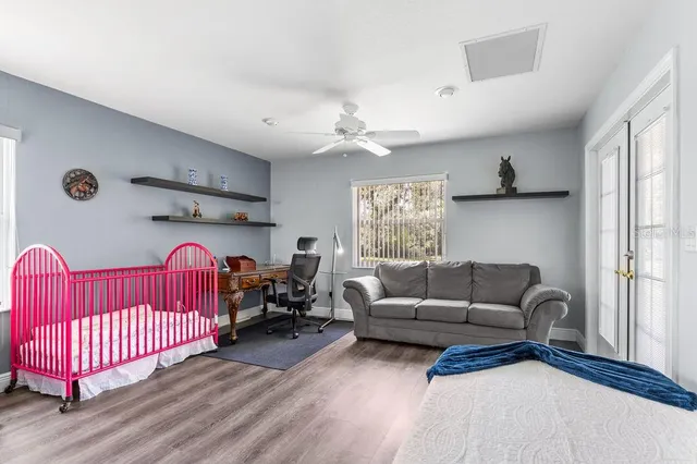 a living room with furniture a ceiling fan and a window