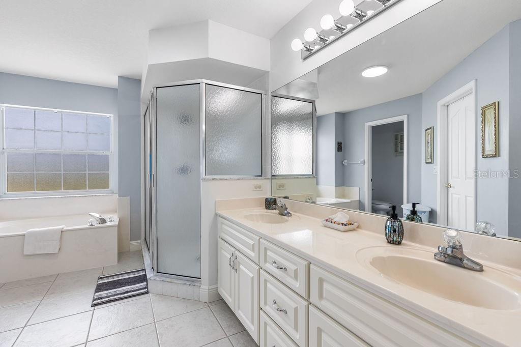 10360 Southwest 48th Avenue Ocala, FL 34476 - Photo 15 of 25 a bathroom with a double vanity sink and a mirror