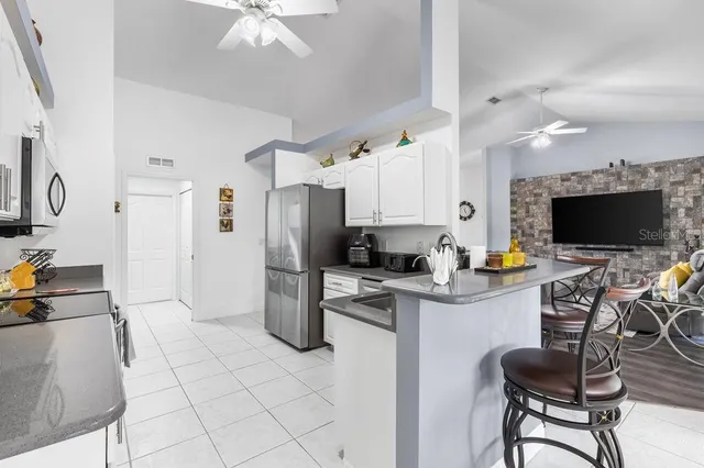 a kitchen with stainless steel appliances a stove refrigerator sink and microwave