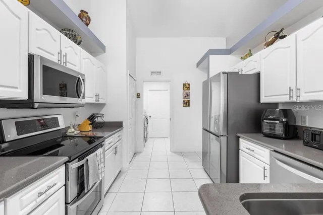 a kitchen with stainless steel appliances a refrigerator stove microwave and sink