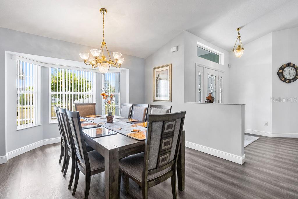 10360 Southwest 48th Avenue Ocala, FL 34476 - Photo 21 of 25 a view of a dining room with furniture window and wooden floor